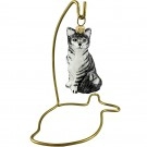 Brass fish ornament stand for cat ornaments.